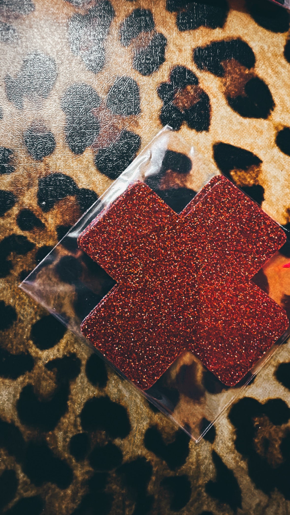 RED GLITTER CROSS SHAPED NIPPLE COVER