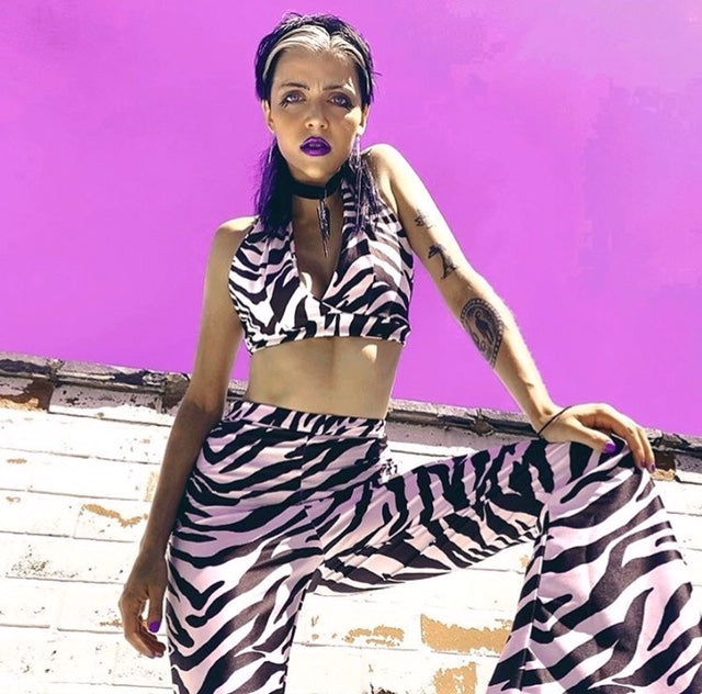 Alternative punk model wears zebra print flares and halter top